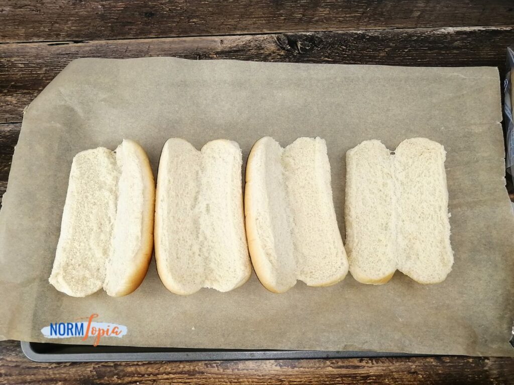 Open your hot dog buns and lay them on a baking sheet lined with parchment paper.